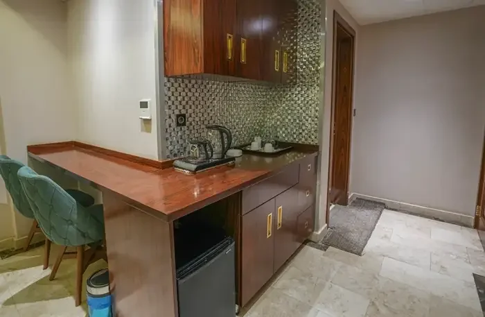 Granada Hotel Najaf custom suite kitchen and kitchenette manufactured with American walnut veneer by I-Hotel Furniture