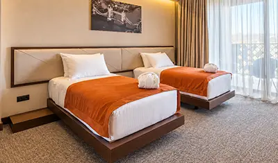American walnut veneer hotel room casegoods and solid beechwood restaurant dining chairs at Bridge Hotel in Tbilisi, Georgia