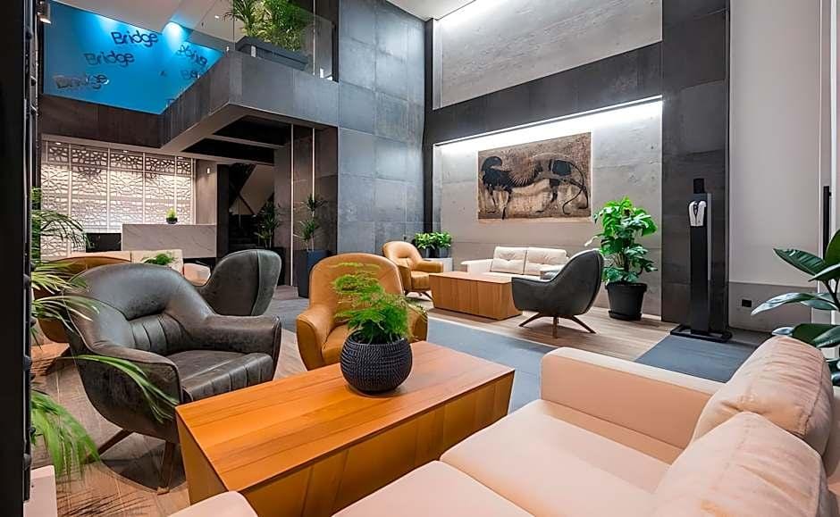 Bridge Hotel Tbilisi lobby lounge sofas armchairs and walnut coffee tables