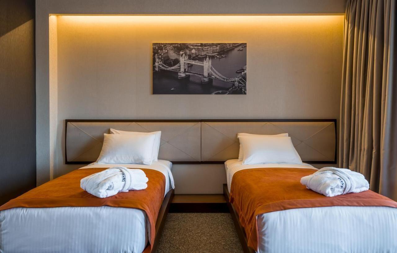 Bridge Hotel Tbilisi Twin Room with two separate beds and custom installed furniture