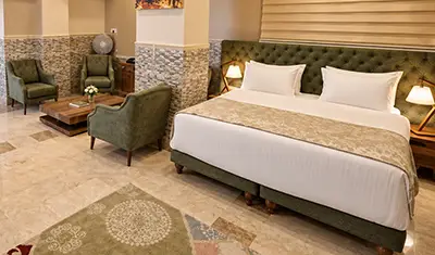 Turkish walnut veneer hotel bedroom furniture, beechwood dining furniture and lounge armchairs at Hotel Royal Eagle in Iraq